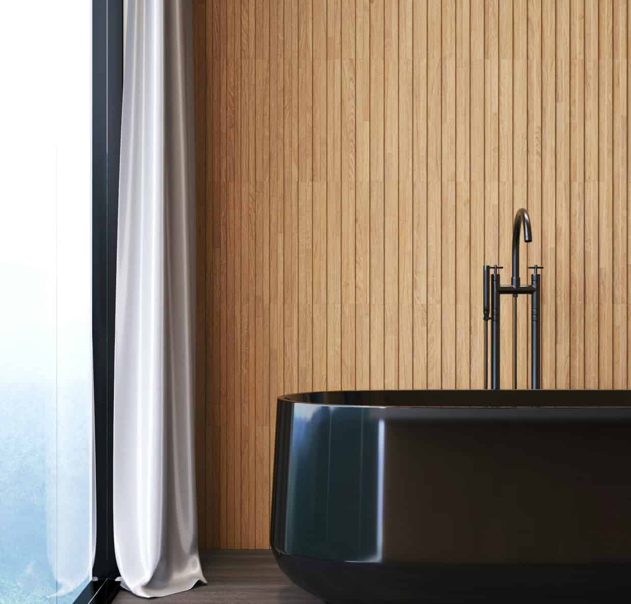 Elegant black bathtub in a contemporary bathroom with wooden wall and natural light.