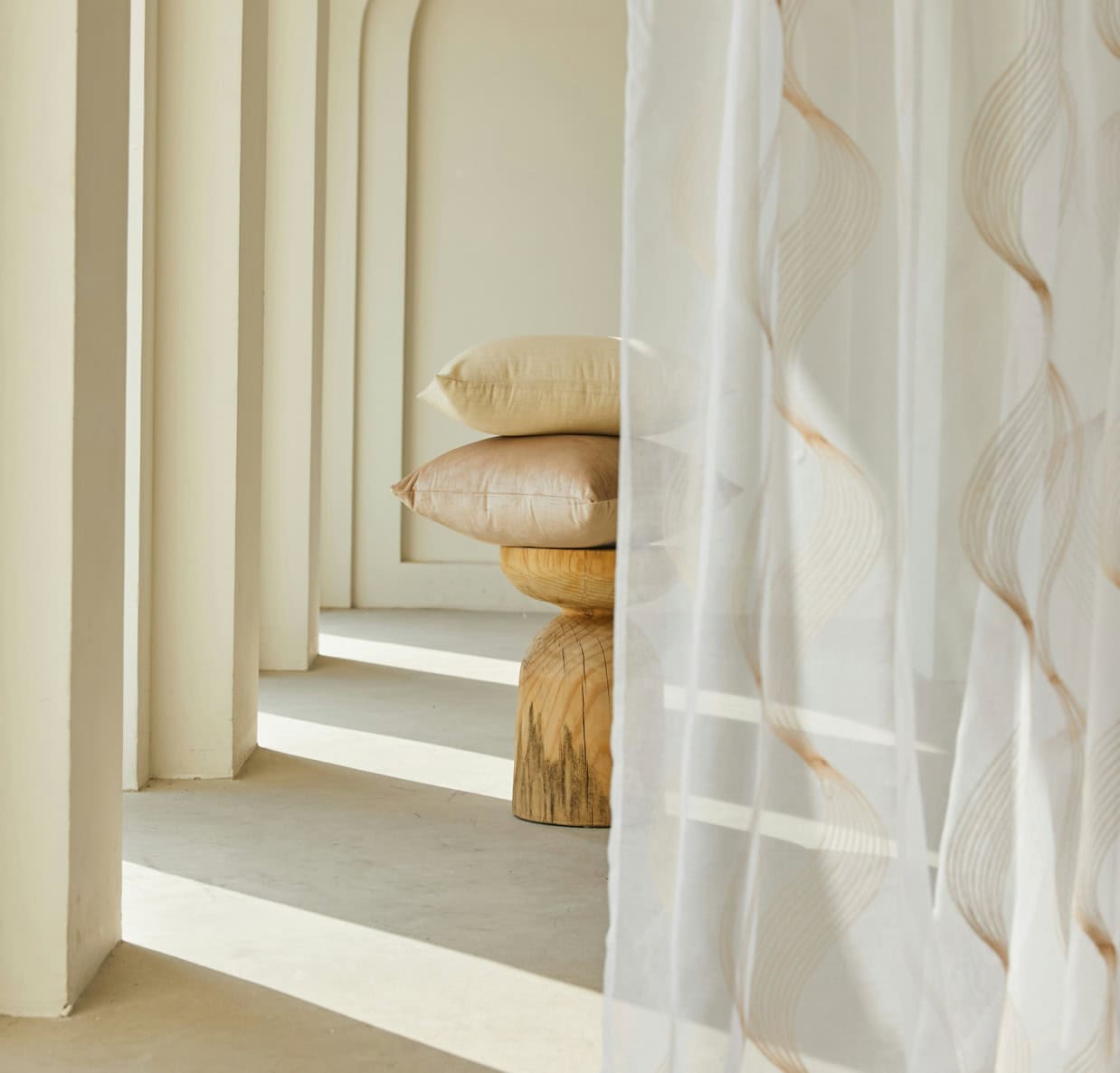 Elegant home decor featuring neutral tones and flowing curtains.