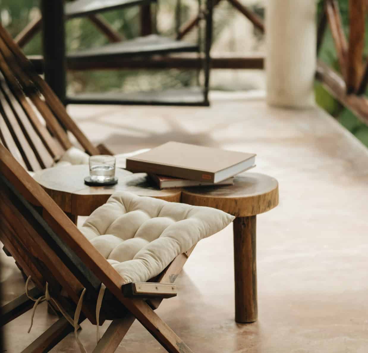 Comfortable outdoor balcony chair with cushion and side table.