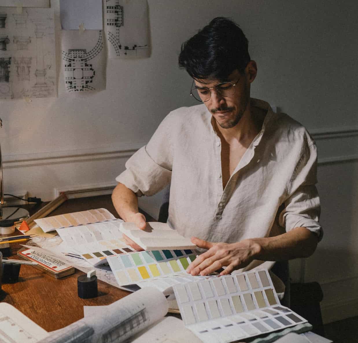 Interior designer examining paint and fabric swatches for home decor.