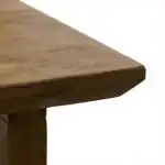 Close-up of a sleek wooden table corner showcasing craftsmanship and natural wood grain.