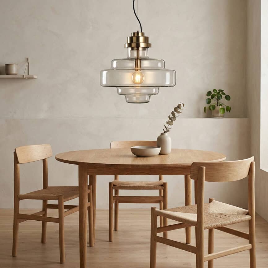 Pendant lamp with layered glass design over dining table.
