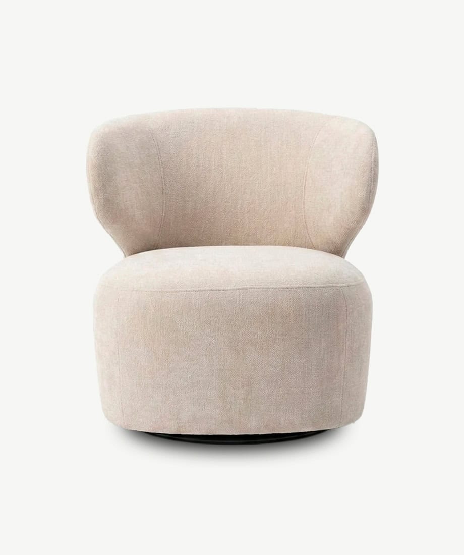 Modern Turis armchair with soft beige upholstery and rounded design.