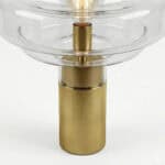 Elegant art table lamp featuring a clear glass shade and brass base for stylish home decor.