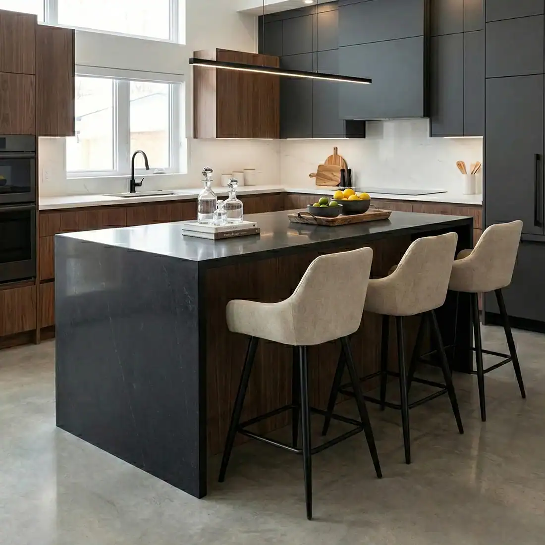 Contemporary kitchen featuring Onda stools around a black island.