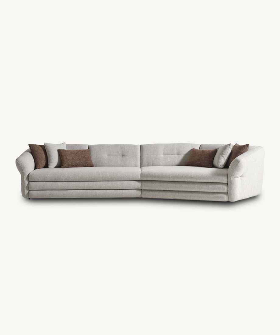 Alcora sofa with neutral fabric, featuring plush cushions and a modern design for stylish living roo.