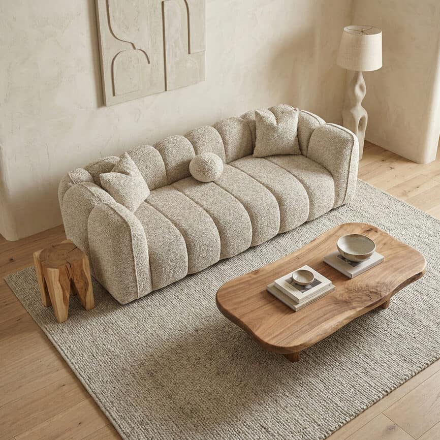 Elegant Vallada sofa with plush, textured fabric in a cozy living room setting.