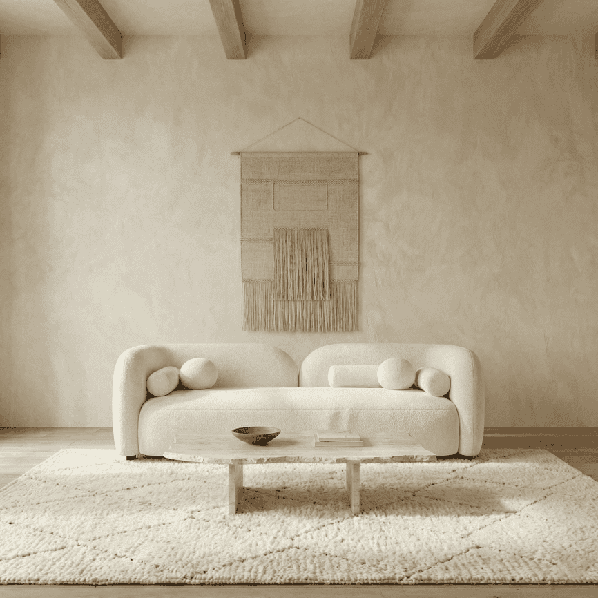 Elegant minimalist living room with neutral tones and cozy decor elements.