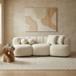 Elegant beige sofa with plush cushions in a contemporary living room setting.
