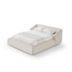 Modern white Liria bed with plush headboard and bedding.