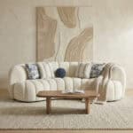 Elegant plush sofa with decorative pillows in a stylish living room setting.