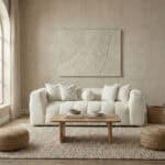Elegant living room featuring a plush white sofa, textured wall art, and natural decor accents.