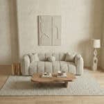 Elegant living room featuring a cozy sofa, abstract wall art, and stylish accessories.