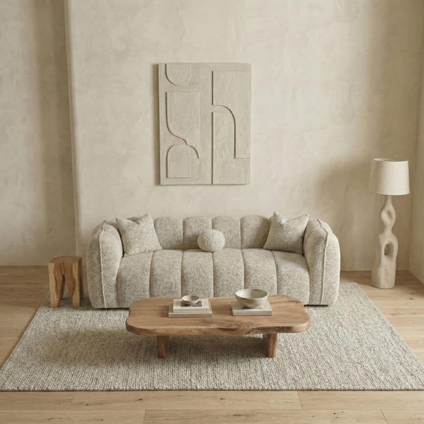 Elegant living room featuring a cozy sofa, abstract wall art, and stylish accessories.