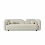 Elegant white Cabanes sofa with unique round cushion accents.
