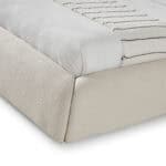 Close-up of the Liria Bed corner showcasing elegant upholstery and craftsmanship.