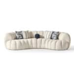 Elegant cream-colored Morella Sofa with plush fabric and decorative cushions for contemporary interi.