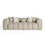 Elegant beige Xera sofa with plush cushions and a central round pillow, perfect for modern living ro.