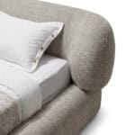 Elegant Ayora Bed with soft, textured upholstery and rounded headboard design.