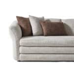 Elegant Alcora sofa in light gray fabric with brown and gray cushions, perfect for contemporary livi.