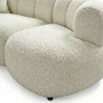 Enguera sofa with plush, textured fabric in a neutral cream color. Perfect for contemporary living s.