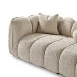 Modern Vallada sofa with plush beige fabric and rounded design.