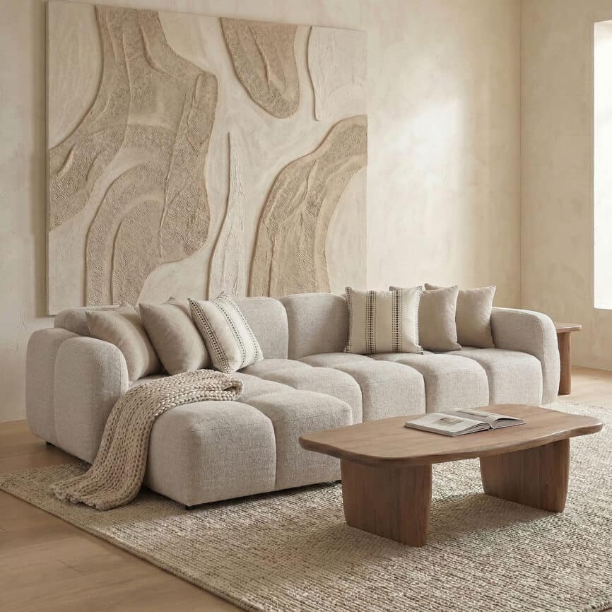 Modern Nules sofa in neutral tones with cozy cushions and textured throw.