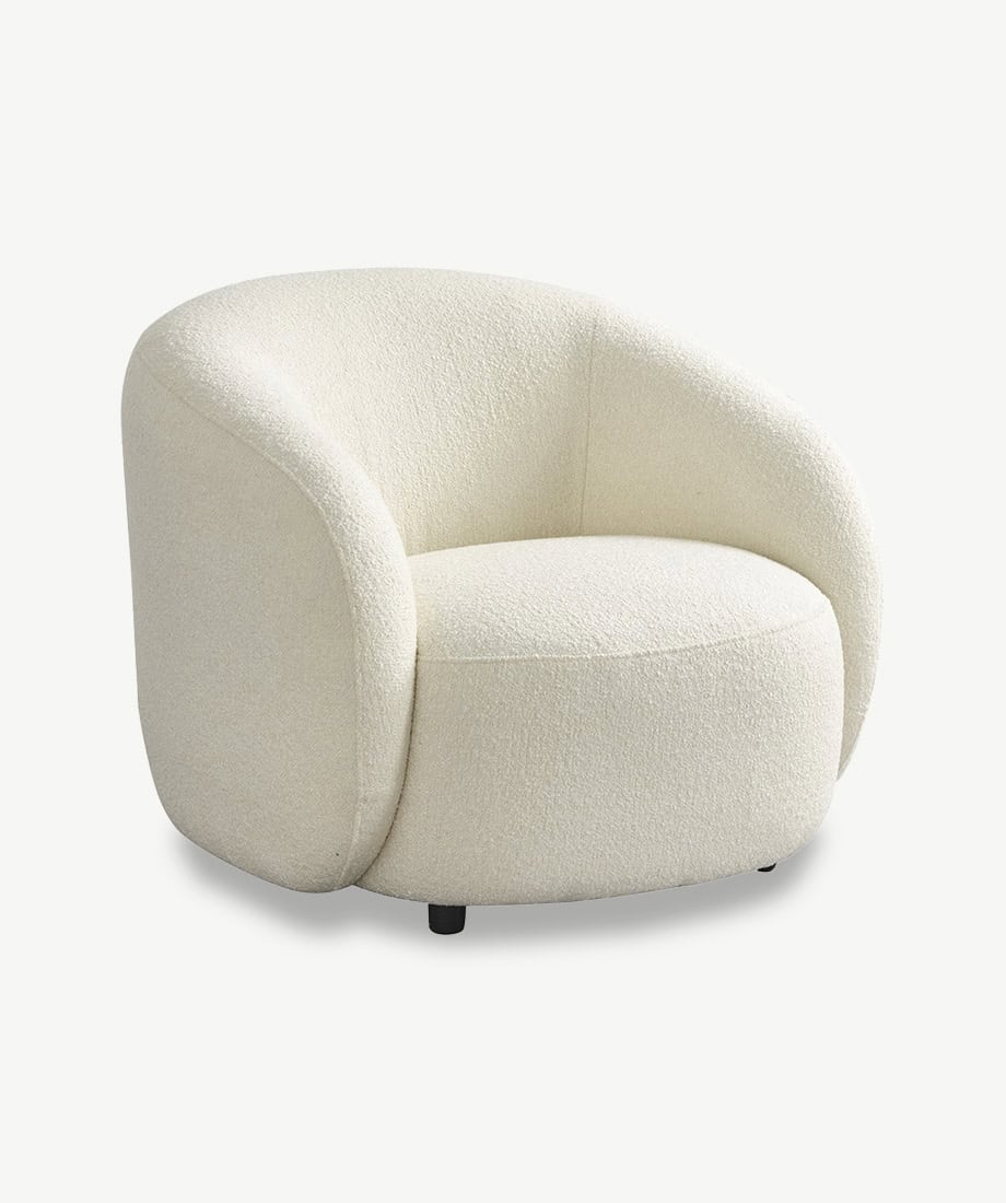 Armchair with plush white fabric and rounded modern design.