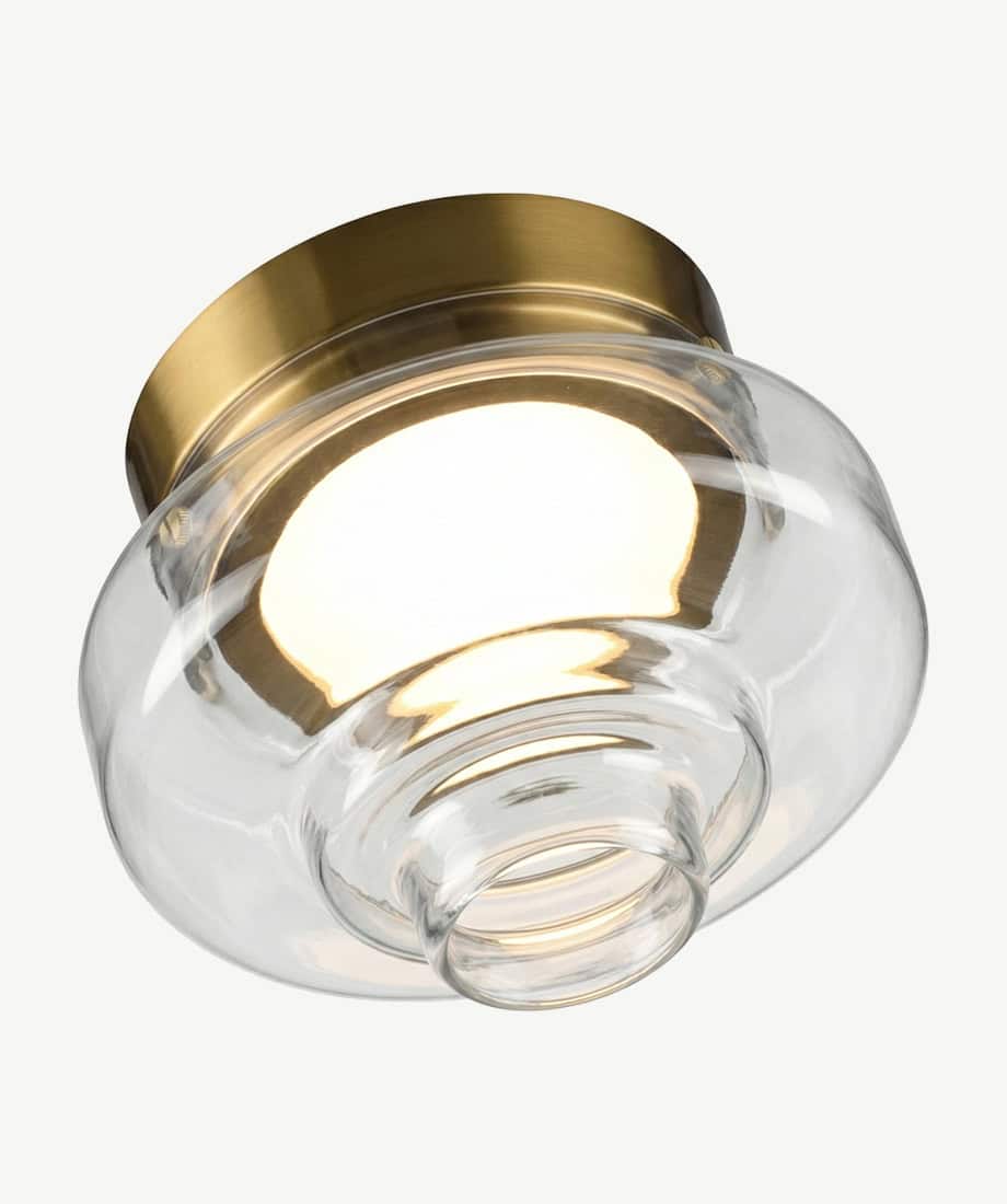 Art wall lamp with glass shade and brass accents for stylish interior lighting.