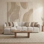 Elegant beige sofa with decorative pillows in a contemporary living room setting.