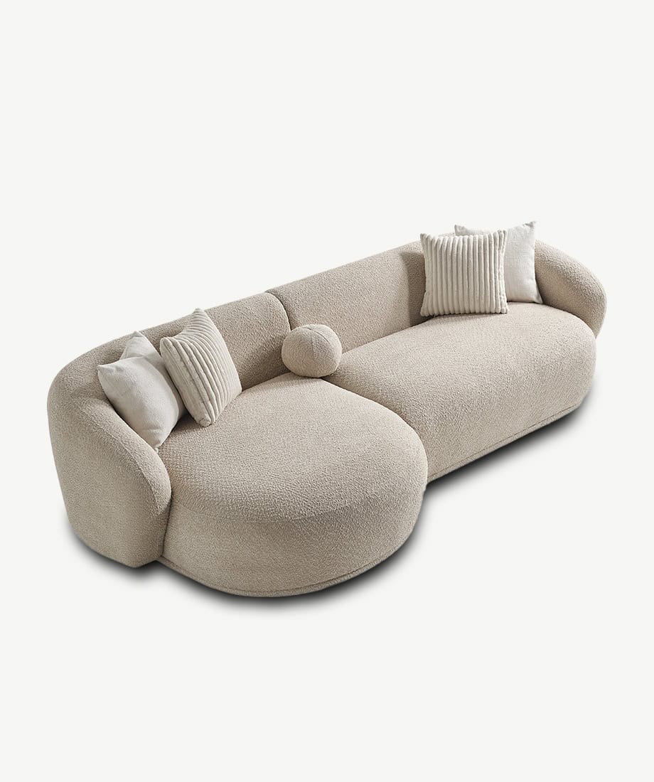 Modern beige Tous sofa with plush cushions and rounded design.