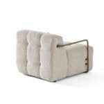 Elegant beige Oropesa armchair with unique design and plush cushioning. Perfect for modern living sp.
