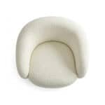 Armchair with plush, textured fabric in a soft cream color. Modern, cozy design perfect for contempo.