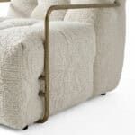 Armchair with unique metal side detail for modern comfort.