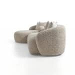 Modern Tous sofa with plush, textured fabric and cozy cushions.