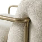 Elegant Oropesa armchair with brass accents and plush upholstery.